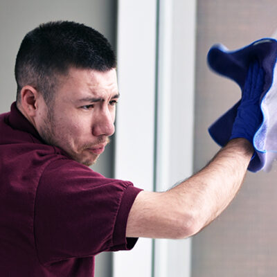 A consumer cleans a window