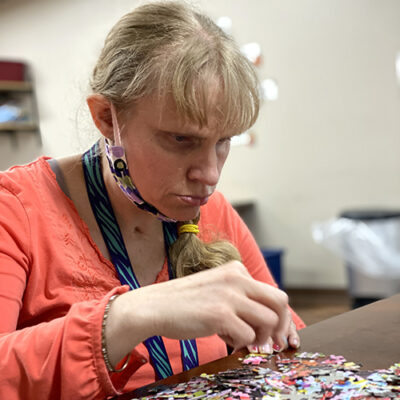 A woman sorts puzzle pieces