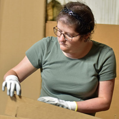 A woman fits cardboard partitions together