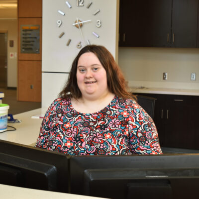 795c Part of Jenny’s work at Manchester is at the reception desk of its Fort Wayne facility.