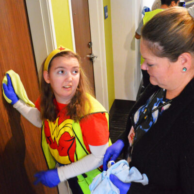 Megan listens to Easterseals Arc staff member Kari Butler as she cleans at the Holiday Inn.