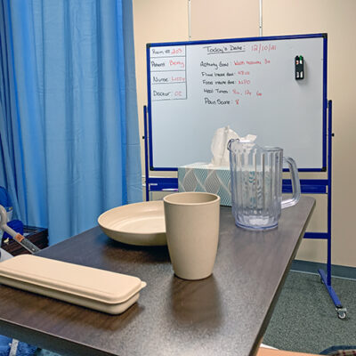 A hospital bed tray with plastic dishware